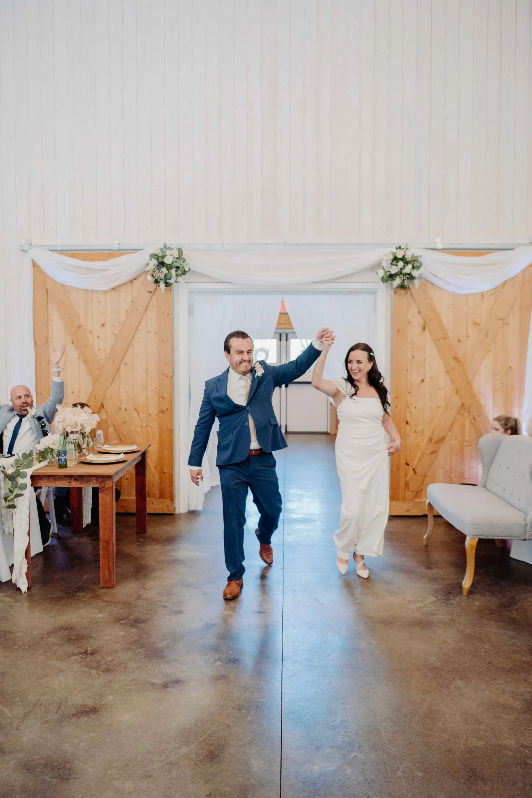 Couple entering the barn reception hand in hand at The Heritage Barn