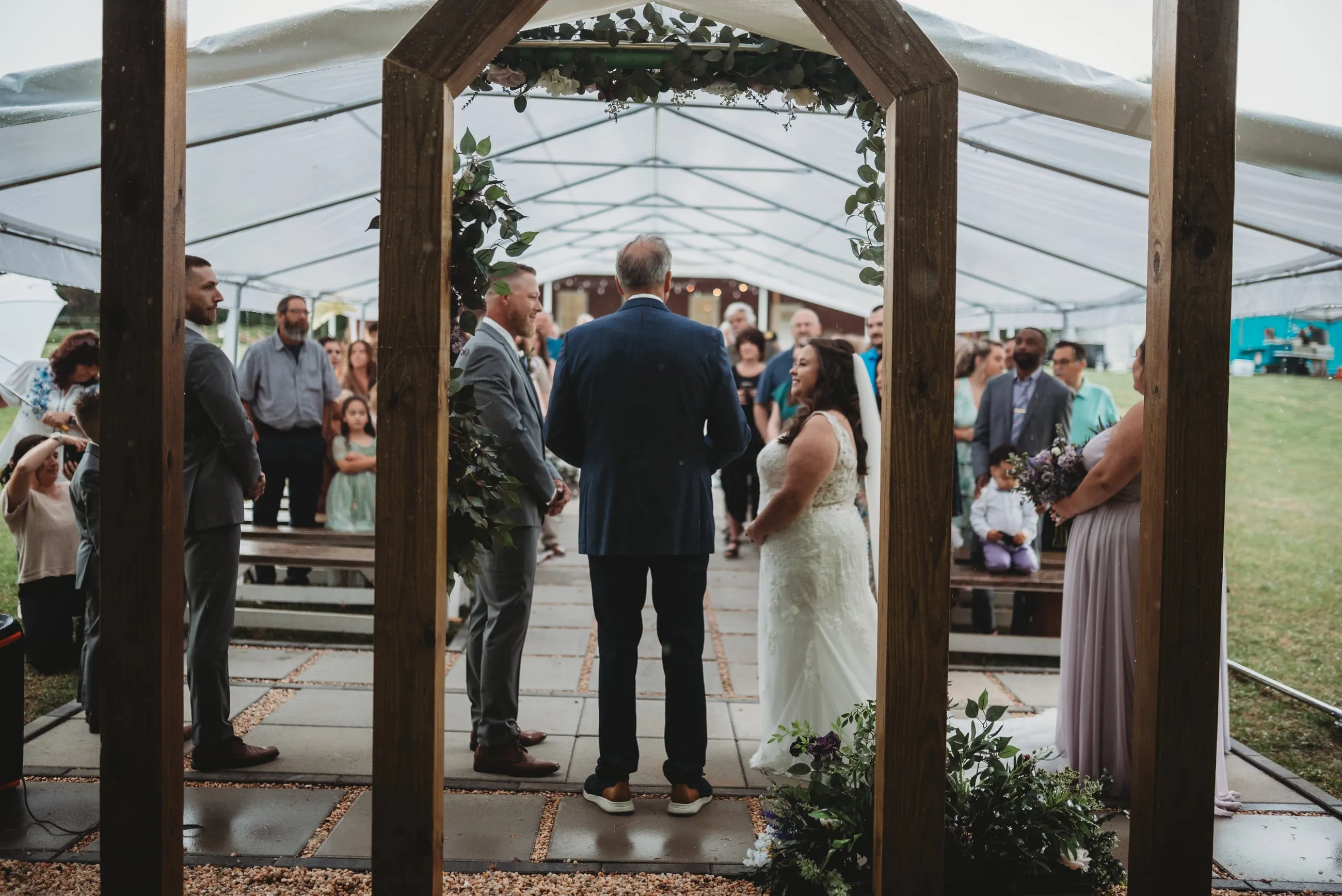 Outdoor wedding ceremony with guests seated on the lawn at The Heritage Barn